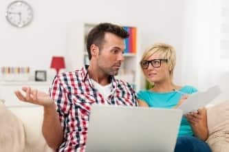 Couple reviewing insurance at computer