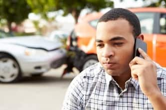 Man on phone after car crash