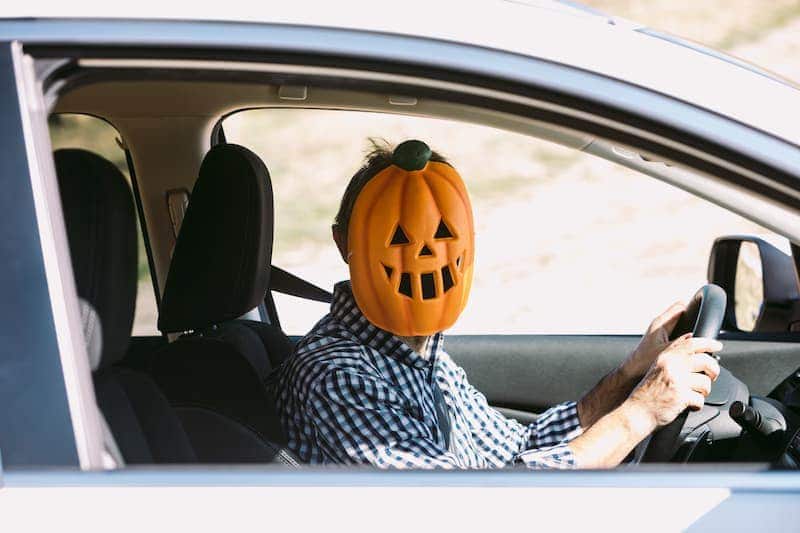 Driver in pumpkin mask